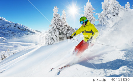 Skier on piste running downhill 40415850