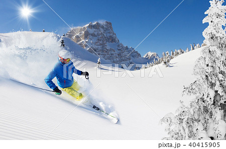 Skier on piste running downhill Skier on piste running downhill 40415905