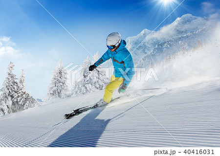 Young man skier running down the slope in Alpine mountains 40416031