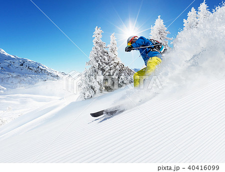 Skier on piste running downhill Skier on piste running downhill 40416099