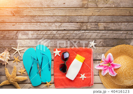 Beach accessories on wooden background Beach accessories on wooden background 40416123