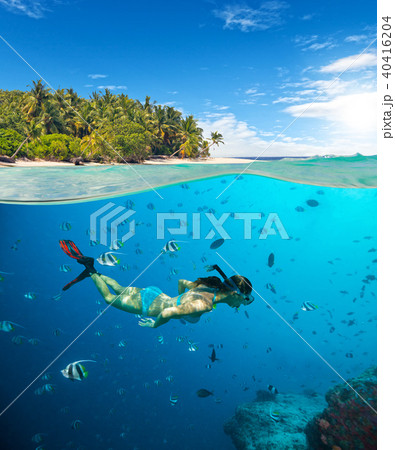 Young woman snorkling on tropical beach 40416204