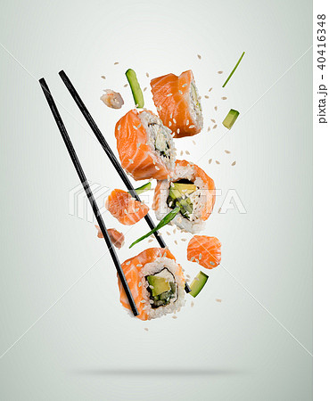 Flying sushi pieces with chopsticks, separated on soft background 40416348