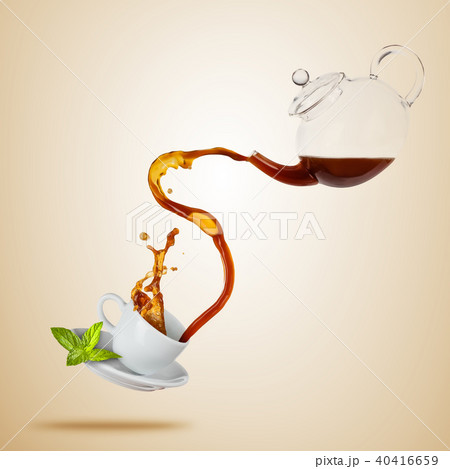 Porcelaine white cup with splashing tea, separated on brown background. 40416659
