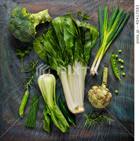 Collection of fresh green vegetables on black stone 40417083