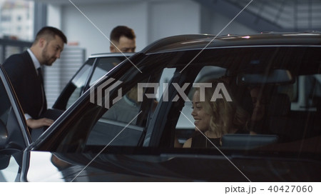 Family taking seats in new car in salon 40427060