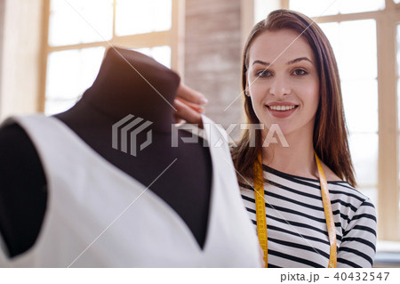 Optimistic female dressmaker designing dress Optimistic female dressmaker designing dress 40432547