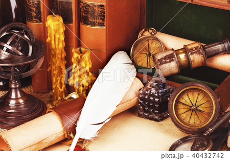 Old books, feather pen and ink bottle, old scroll  40432742