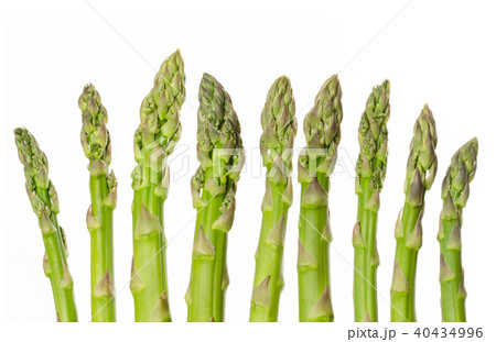 Fresh green asparagus tips in a row over white Fresh green asparagus tips in a row over white 40434996