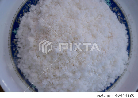 Grated coconut in a white dish. 40444230