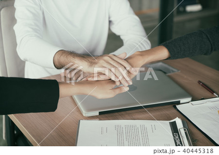 Three business partners team with hands together 40445318