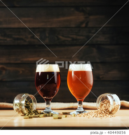 Two glasses of beer on a wooden table grains Two glasses of beer on a wooden table grains 40449856