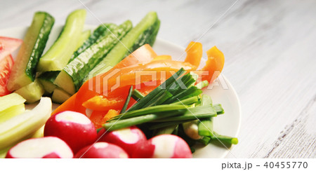 White plate with vegetables for a vegetarian salad White plate with vegetables for a vegetarian salad 40455770