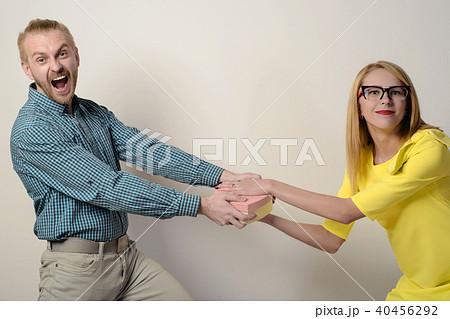 couple are fighting for box in the shape of heart. 40456292