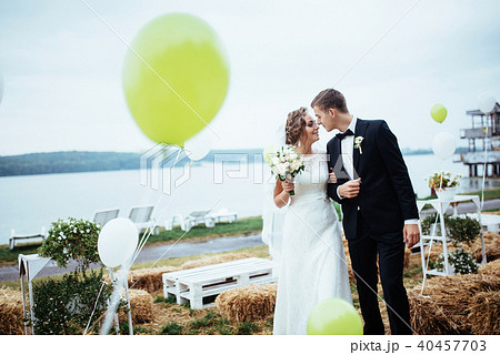 beautiful young wedding couple kissing , blonde bride with flowe 40457703