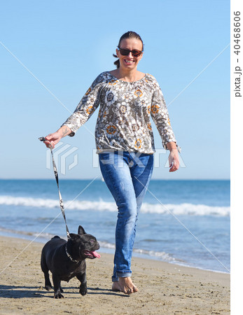 woman and dog on the beach woman and dog on the beach 40468606
