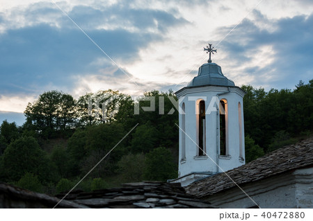 Orthodox church lit dome with cross at evening 40472880