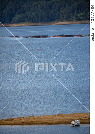 Waters of the lake, sand and lonely fishing boat Waters of the lake, sand and lonely fishing boat 40472884