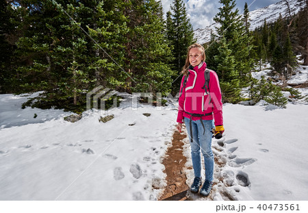 Tourist with backpack hiking on snowy trail Tourist with backpack hiking on snowy trail 40473561