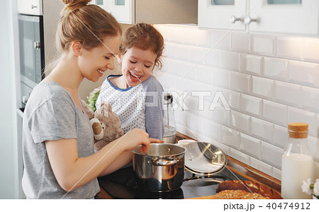 preparation of family breakfast. mother and child daughter cook preparation of family breakfast. mother and child daughter cook 40474912