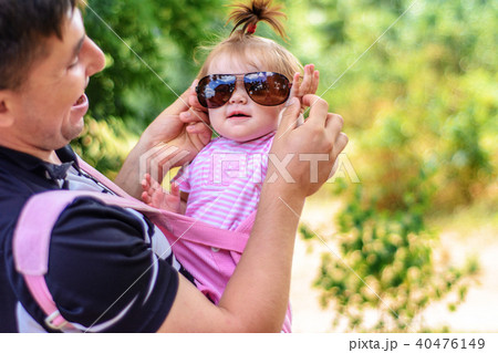 Amazing little girl is playing with sunglasses with her father Amazing little girl is playing with sunglasses with her father 40476149