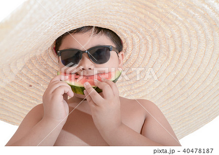 Happy fat boy wear sunglasses and big hat eating watermelon Happy fat boy wear sunglasses and big hat eating watermelon 40478187