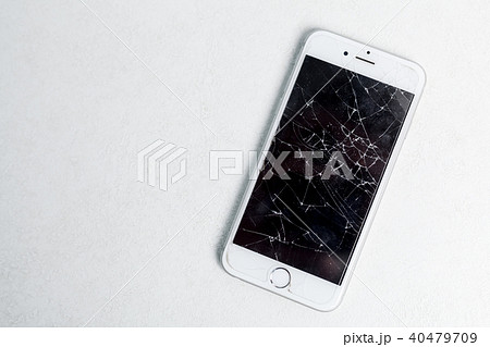 Broken mobile phone screen, scattered shards.  40479709