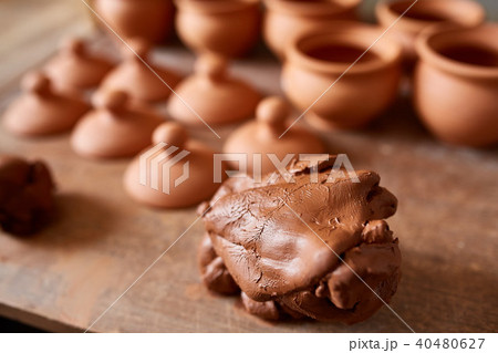 Making pottery on a potter's wheel in the workshop, close-up, selective focus. 40480627