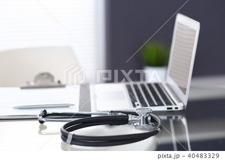 Stethoscope, prescription medical form lying on glass table with laptop computer. Medicine or Stethoscope, prescription medical form lying on glass table with laptop computer. Medicine or 40483329