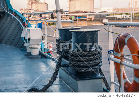 mooring equipment of ship. Mooring lines are fast on bollards, capstan and winch 40483377