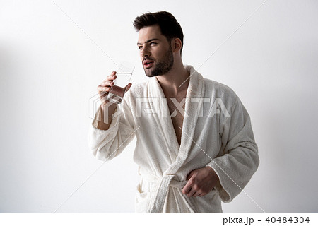 Pensive guy is enjoying beverage 40484304
