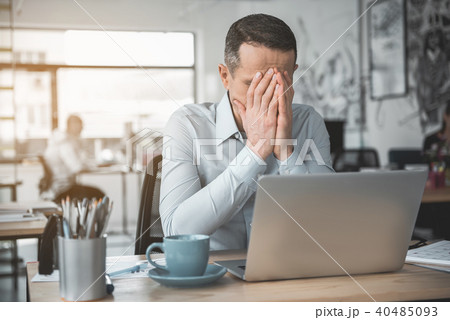 Worried businessman locating at desk Worried businessman locating at desk 40485093
