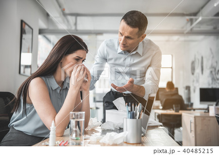Unhappy sick female and calm colleague 40485215