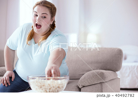 Stout young woman has a sweet tooth 40492782