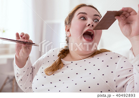 Crazy red-head woman eating sweets non stop 40492893