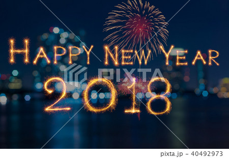 Happy new year 2018 written with Sparkle firework on fireworks with dark background, celebration and greeting cards concept Happy new year 2018 written with Sparkle firework on fireworks with dark background, celebration and greeting cards concept 40492973