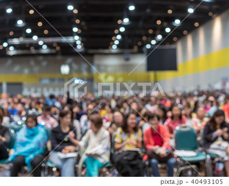 Abstract blurred photo of conference hall or seminar room in Exhibition Center with speakers on the stage and attendee background, seminar and study concept Abstract blurred photo of conference hall or seminar room in Exhibition Center with speakers on the stage and attendee background, seminar and study concept 40493105