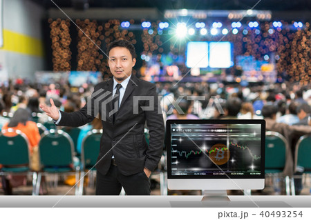 Businessman giving the knowledge with showing Cryptocurrency trading screen, Bitcoin exchange screen of trading information over blurred photo of attendee in Exhibition Center,Business Seminar concept Businessman giving the knowledge with showing Cryptocurrency trading screen, Bitcoin exchange screen of trading information over blurred photo of attendee in Exhibition Center,Business Seminar concept 40493254