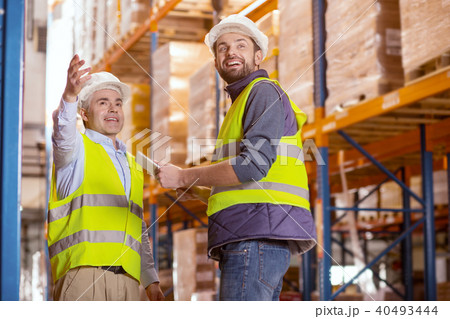 Delighted positive men smiling Delighted positive men smiling 40493444