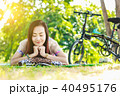 Asian woman  reading a book in the park. 40495176