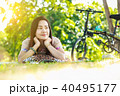 Asian woman smiling  reading a book in the park. 40495177