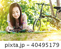 Asian woman  reading a book in the park. 40495179