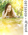 Asian woman  reading a book in the park. 40495180
