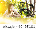 Asian woman  reading a book in the park. 40495181