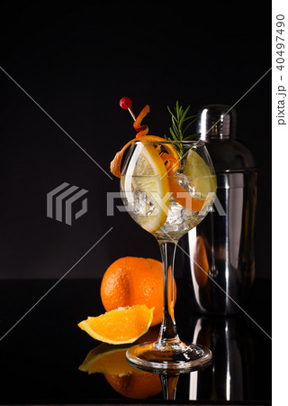 Glass of a cold cocktail drink with white wine served with brown sugar, orange and shaker 40497490