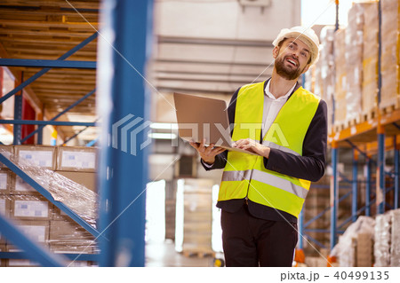 Smart positive man observing the working process Smart positive man observing the working process 40499135