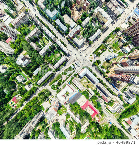 Aerial city view with crossroads and roads, houses, buildings, parks and parking lots. Sunny summer Aerial city view with crossroads and roads, houses, buildings, parks and parking lots. Sunny summer 40499871