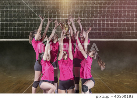 Woman volleyball Players celebrating victory and gold medal 40500193