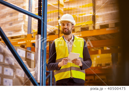 Joyful positive man doing the revision Joyful positive man doing the revision 40500475