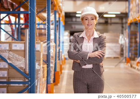Delighted confident businesswoman standing in the warehouse 40500577